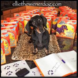 Ellie pawtographing her book It's Hard to be Good